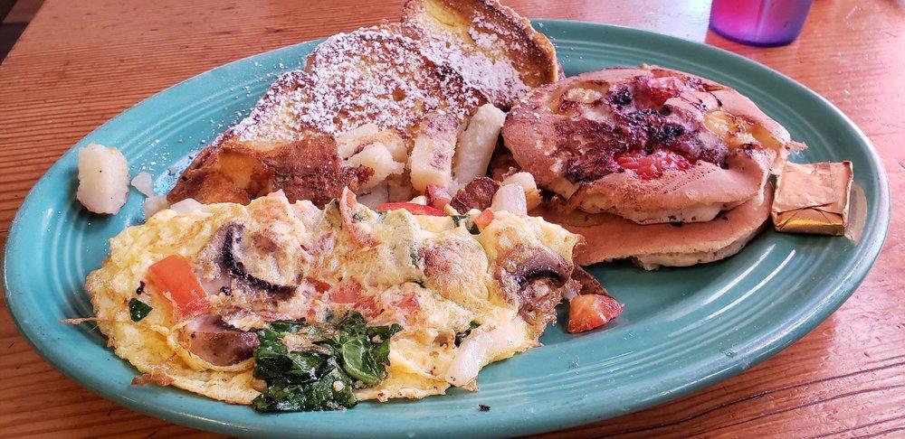 Sundeck Combo D · Two chocolate chip banana pancakes, one strawberry banana crepe, veggie omelet and fruit salad.