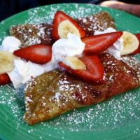 Strawberry and Banana Crepe · Topped with fruit, whipped cream and powdered sugar.