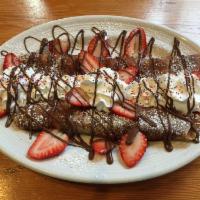Strawberry and Nutella Crepe · Topped with fruit, whipped cream and powdered sugar.
