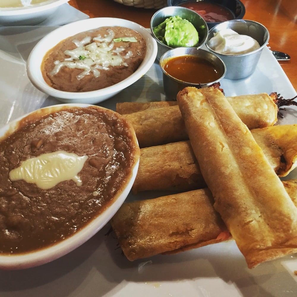 Chicken Flautas · 2 crispy flour tortillas stuffed with chicken & topped with nacho cheese. Served with lettuce, sour cream, guacamole, rice & beans.