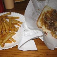 Philly Cheese Steak Sandwich · Thinly sliced top choice beef or chicken with onions, your choice of provolone or white Amer...