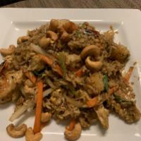 Pineapple Fried Rice · Stir-fried shrimp and chicken fried rice with lightly browned cashew nuts, eggs, white and g...