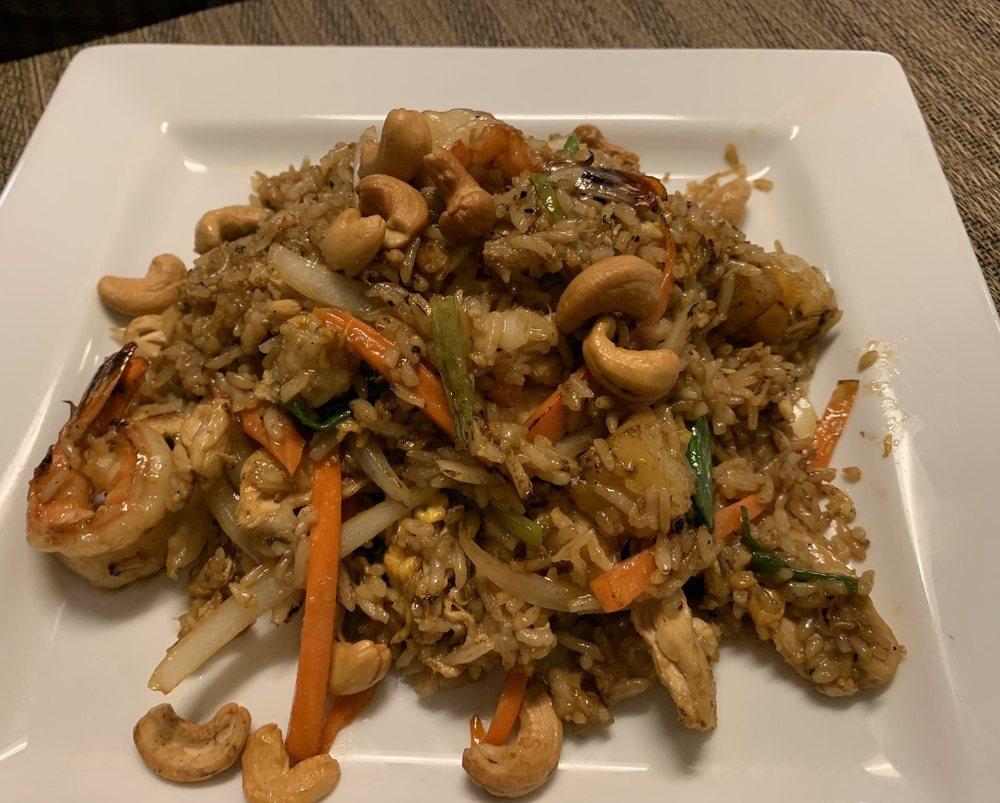 Pineapple Fried Rice · Stir-fried shrimp and chicken fried rice with lightly browned cashew nuts, eggs, white and green onion, carrots, sweet and sour pineapple and a fresh lice of lime.