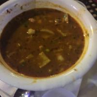 Menudo · Beef tripe and hominy, simmered in a spicy broth served with chopped onion, cilantro, lime, ...