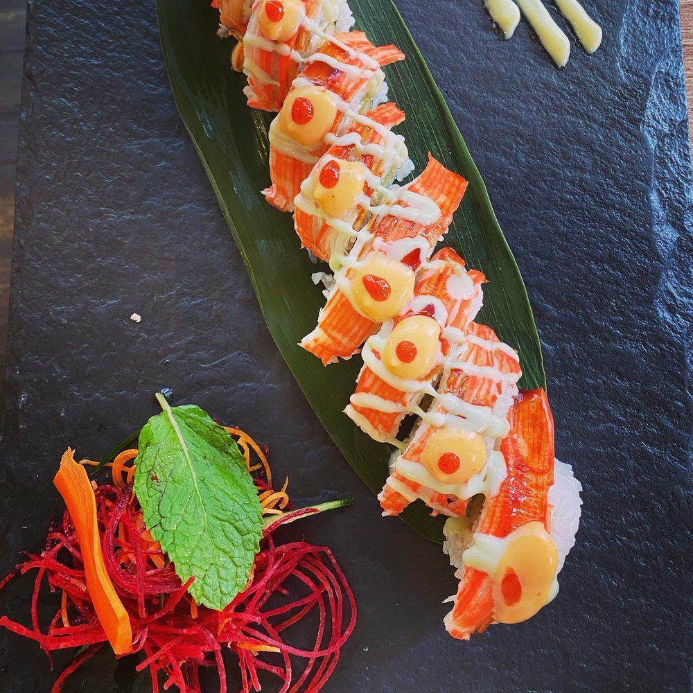 Fuji Mountain Roll · Shrimp tempura, snow crab, avocado, topped with crab stick, and served with 4 different kinds of sauce.