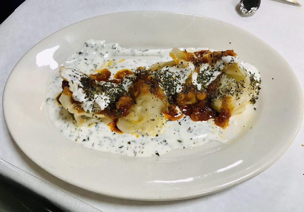 Mantu · Steamed dumplings stuffed with ground beef, onions, cilantro and spices. Topped with our homemade garlic mint yogurt sauce and garnished with lamb gravy and yellow split peas.