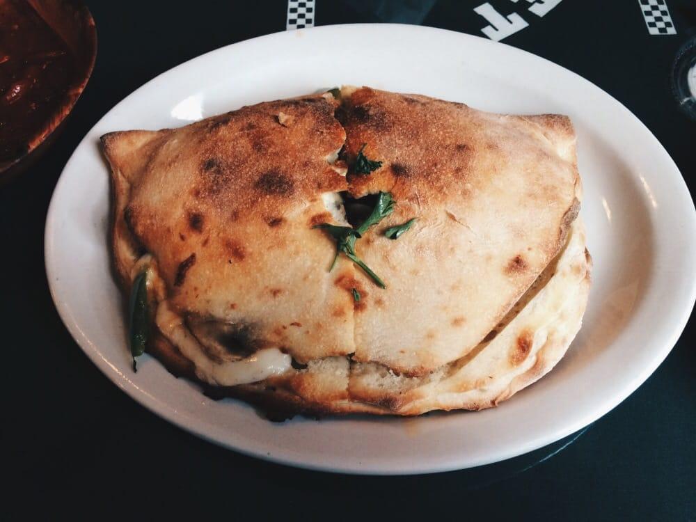 Calzone · Filled with mozzarella, Parmesan, ricotta cheese and choice of 2 pizza toppings.