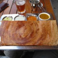 Onion Masala Dosa · Thin rice and lentil crepe filled with potatoes and onions.
