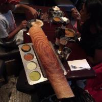 Paper Masala Dosa · Thin, lengthy rice and lentil crepe filled with mildly spiced mashed potatoes and onions.