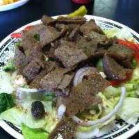 Grecian Gyro Salad · Our Greek salad topped with fresh slices of gyro meat.