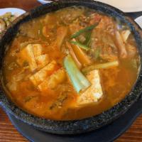 Kimchi Jjigae · Spicy kimchi soup made with tofu and pork, served in hot stone bowl. Spicy.