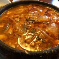 Tofu Stew · Extra soft premium tofu soup with clam, shrimp and an egg in hot broth served in a stone pot...