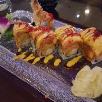 Redskins Roll · In shrimp tempura and spicy kani. Out spicy crunchy tuna, red tobiko, mango on top with spic...