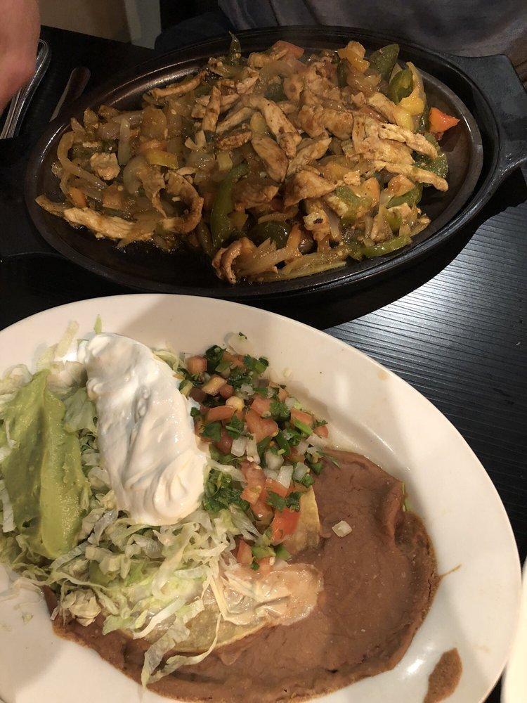 Fajitas · Chicken or steak strips grilled with bell peppers, onions and tomatoes. Served with beans guacamole salad pico de gallo and flour tortillas. Mixed chicken and steak for an additional charge.