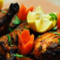 Tandoori Chicken · Whole chicken bird cut into 4 or 8 pieces marinated in a house special marinade roasted in t...
