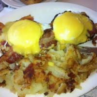 Eggs Benedict Breakfast · 2 poached eggs with Canadian bacon served over an English muffin and topped with hollandaise...