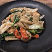 Drunken Noodles · Flat rice noodles sauteed with egg, peppers, tomatoes, onions, Chinese broccoli and basil le...