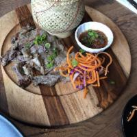 Crying Tiger · Grilled marinated ribeye served with sticky rice and roasted tomato dip.
