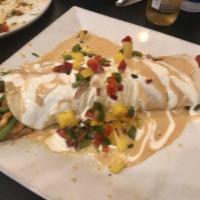 Burrito Chipotle · 1 flour tortilla filled with grilled chicken, rice, beans and peppers, topped with a creamy ...