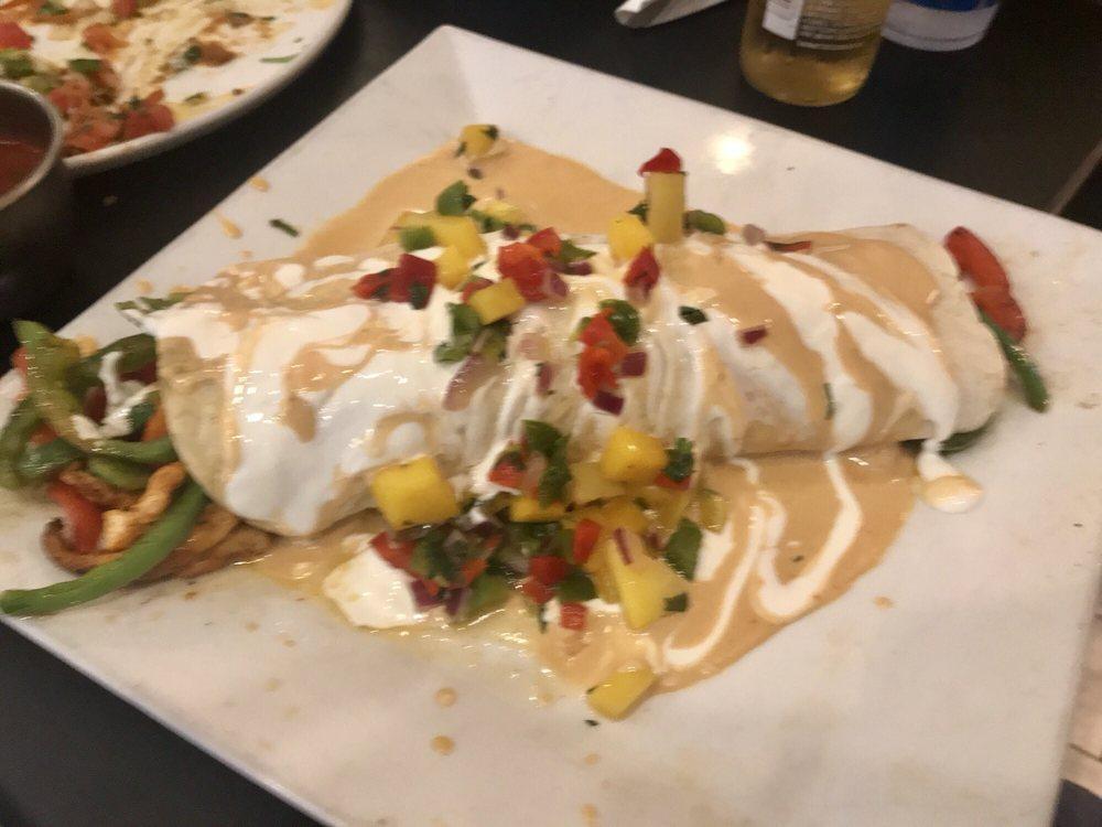 Burrito Chipotle · 1 flour tortilla filled with grilled chicken, rice, beans and peppers, topped with a creamy chipotle sauce, pico de gallo and sour cream.