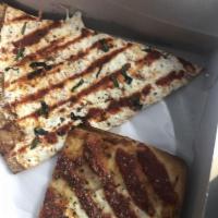 Grandma Slice · Square, super thin, crispy crust with parmesan cheese and marinara sauce