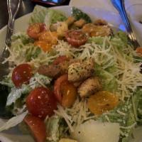 Caesar Salad · Chopped romaine hearts, cherry heirloom tomatoes, home made Caesar dressing and croutons. In...