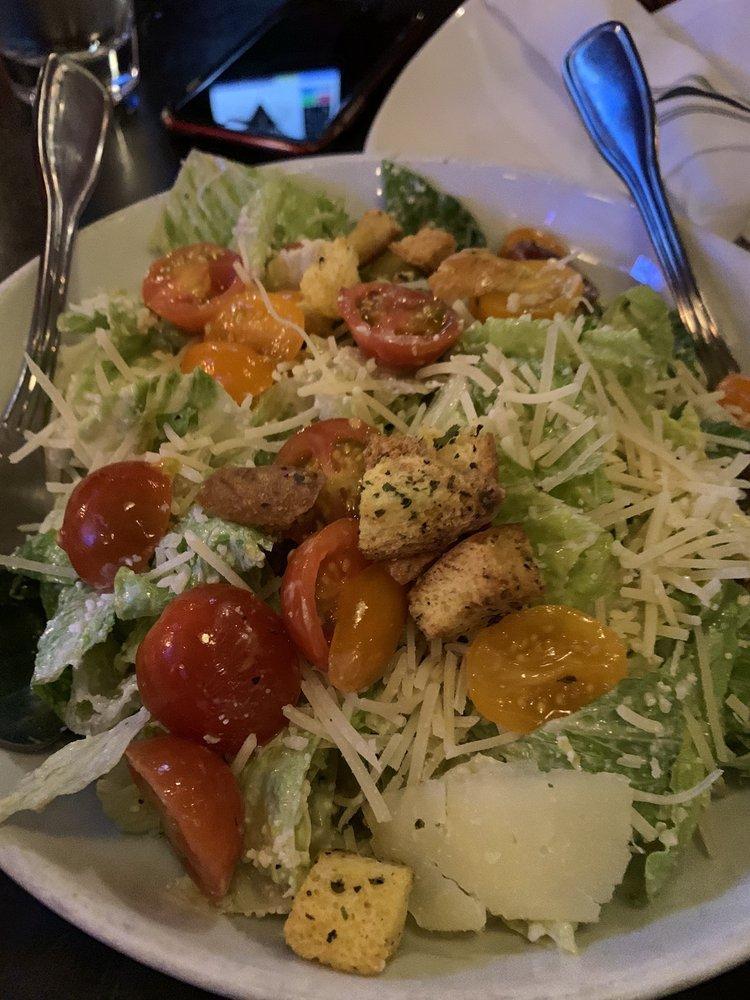 Caesar Salad · Chopped romaine hearts, cherry heirloom tomatoes, home made Caesar dressing and croutons. Includes gluten.