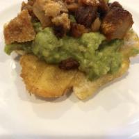 Tostones With Guacamole Y Chicharron · Fried green plantain served with guacamole and fried pork grinds.