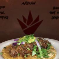 Beef Barbacoa Taco · Slow braised beef, red onion, salsa verde, cilantro and double corn tortilla.