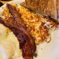Bacon and Eggs · 2 eggs scrambled with bacon or sausage with hash browns and toast.