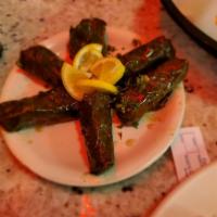 Dolmas · Tender grape leaves stuffed with rice, spices and herbs in olive oil.