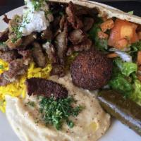 Greek Gyro Plate · Comes with basmati rice, falafel, hummus, fattoush salad, dolmas and fresh pita.