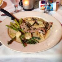 Veal Piccata · Cutlet sauteed with chablis, lemon, capers, artichokes, and cream, served with capellini pas...