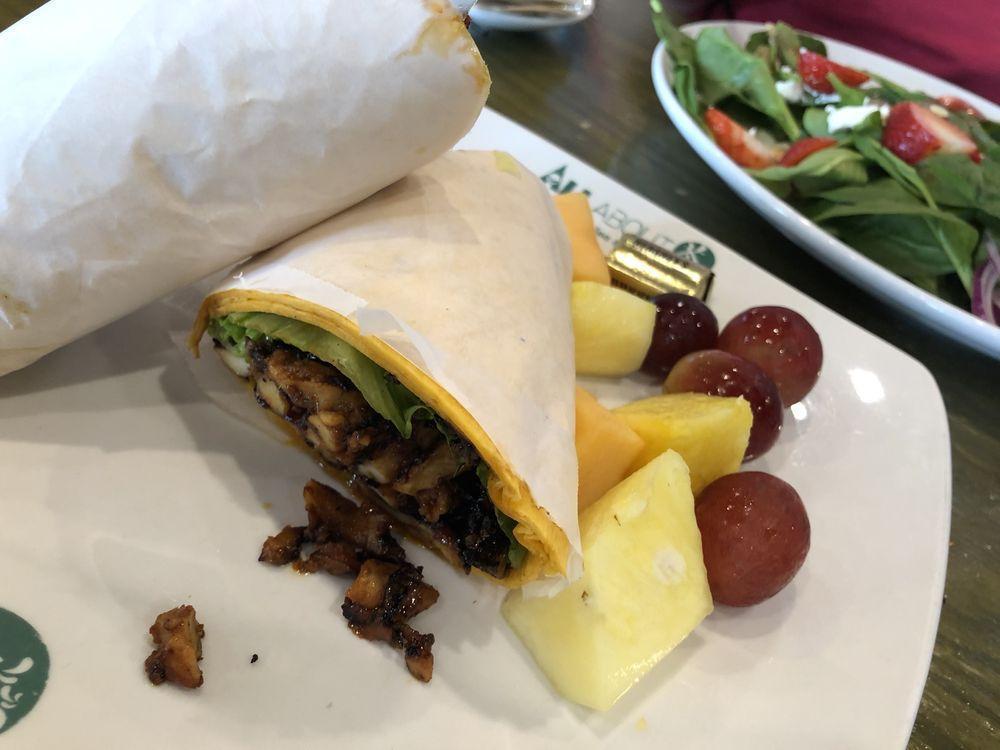 Dakgalbi Wrap · Freshly made and house spicy marinated Korean dakgalbi chicken. Sautéed with yellow onions and carrots. Wrapped in a jalapeño cheddar tortilla wrap with romaine. Comes with a side of chips or fresh fruit. (Pineapple, melon, and grapes).