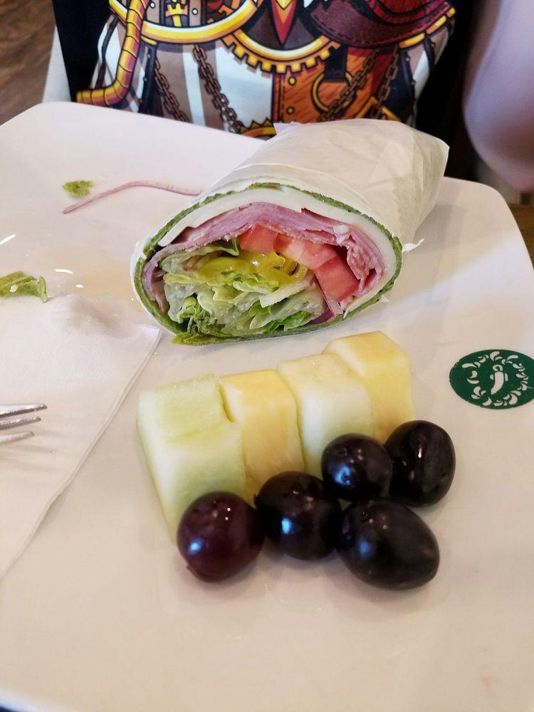 Italian Wrap · Freshly made Italian wrap with a side of chips or fresh fruits. (Pineapple, melon, and grapes). Wrapped in a spinach tortilla wrap. Contains: provolone cheese, ham, banana peppers, red onion, tomato, and romaine lettuce.