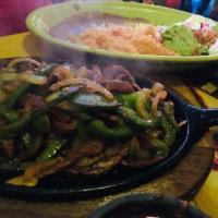 Fajitas · Sauteed chicken or grilled steak with sauteed onions and bell peppers.