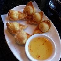 Crab Rangoon · Blended crab and cream cheese wrapped in a wonton skin and fried.