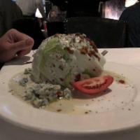 The Wedge Salad · Crumbled blue cheese and crispy bacon.