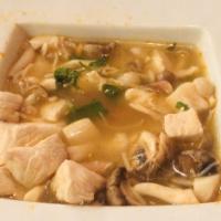 Tom Yum Soup · Traditional Thai hot and sour soup lemongrass soup with fresh mushrooms, lemongrass, tomatoe...