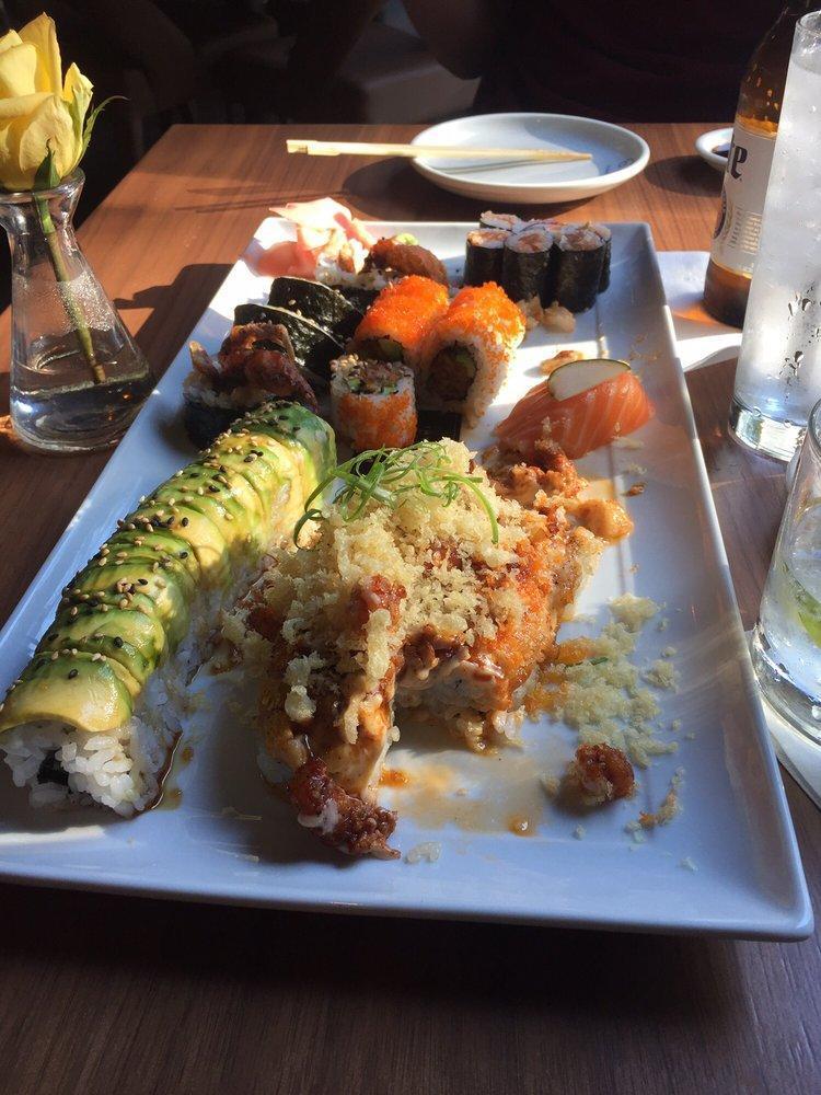 Black and Gold Roll · Temp shrimp, cucumber, crab stick, baked with spicy mayo, crawfish, scallion topped with crunchies, tsurai, and tsu sauce.