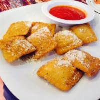 Fried Ravioli · Ricotta filled ravioli breaded fried & topped with parmesan. Served with a side of marinara.
