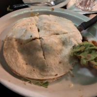 Quesadillas · Flour tortillas stuffed with melted cheese. Served with guacamole and lettuce.