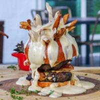 The Fondue Burger · French fries on a top of the buns, 2 beef patties, caramelized onions and our cheese fondue ...