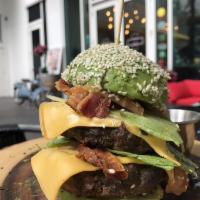 Avocado Burger · In an avocado instead of a regular buns, 2 beef patties, bacon, tomato, salad and cheddar.