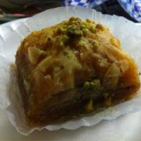 Baklava · Crispy filo dough layered with walnut with walnuts and drenched in sweet syrup.
