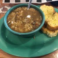 Seafood Gumbo · Shrimp and crawfish over white rice served with French bread.