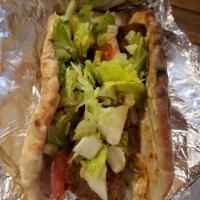 Gyro Sandwich · Rotisserie broiled spiced lamb and beef thinly sliced, served on a bed of tzatziki sauce, wr...