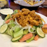 Buffalo Chicken Salad · Chopped buffalo chicken tenders on top of romaine lettuce, cucumbers, celery, and carrots, s...