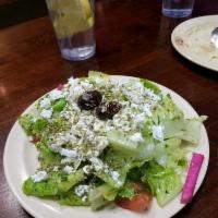 Greek Salad · Lettuce, tomato, cucumber, green onion and black olive seasoned with sumac, mint, lemon juic...