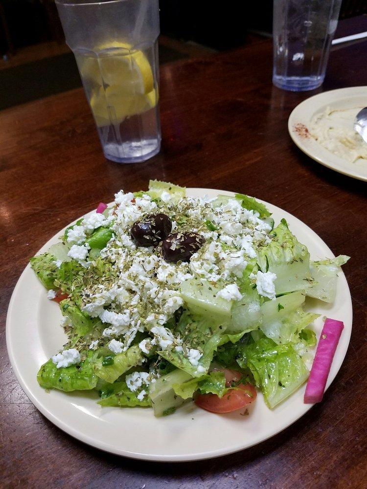 Greek Salad · Lettuce, tomato, cucumber, green onion and black olive seasoned with sumac, mint, lemon juice and olive oil topped with feta cheese and oregano.
